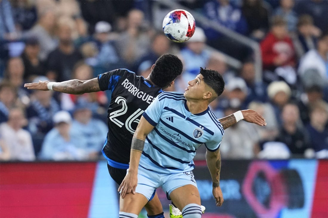 Oct 25, 2023; Kansas City, KS, USA; Sporting Kansas City forward Alan Pulido (9) battles San Jose Earthquakes defender Rodrigues (26) for the ball in the second half in the Western Conference Wild Card match of the 2023 MLS Cup Playoffs at Children's Mercy Park. Mandatory Credit: Jay Biggerstaff JB-USA TODAY Sports