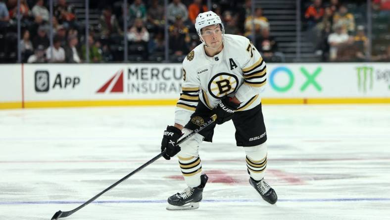 Oct 22, 2023; Anaheim, California, USA;  Boston Bruins defenseman Charlie McAvoy (73) skates with the puck during the NHL game against the Anaheim Ducks at Honda Center. Mandatory Credit: Kiyoshi Mio-USA TODAY Sports