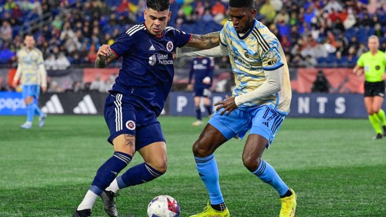 Oct 21, 2023; Foxborough, Massachusetts, USA; New England Revolution forward Gustavo Bou (7) battles Philadelphia Union defender Damion Lowe (17) for the ball during the second half at Gillette Stadium. Mandatory Credit: Eric Canha-USA TODAY Sports