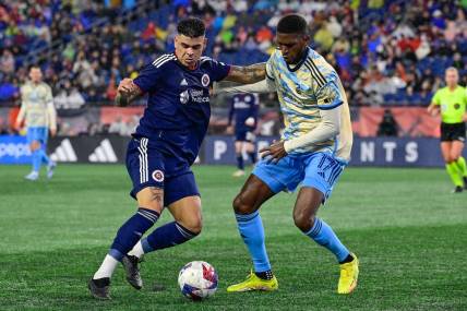 Oct 21, 2023; Foxborough, Massachusetts, USA; New England Revolution forward Gustavo Bou (7) battles Philadelphia Union defender Damion Lowe (17) for the ball during the second half at Gillette Stadium. Mandatory Credit: Eric Canha-USA TODAY Sports