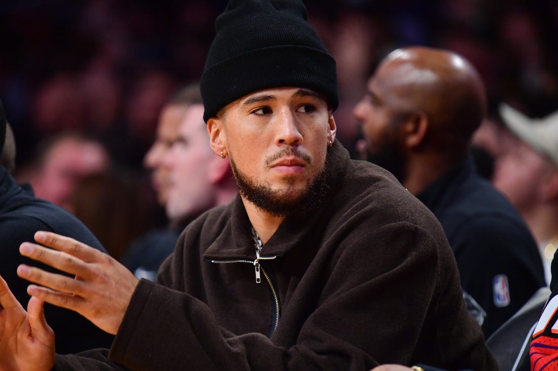 Oct 26, 2023; Los Angeles, California, USA; Phoenix Suns guard Devin Booker (1) watches game action against the Los Angeles Lakers during the first half at Crypto.com Arena. Mandatory Credit: Gary A. Vasquez-USA TODAY Sports