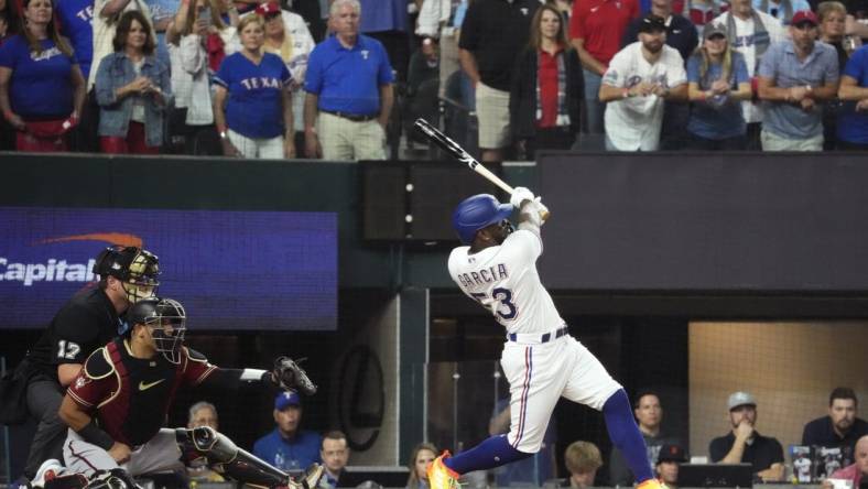 Texas Rangers right fielder Adolis Garcia (53) hits an RBI single during the first inning against the Arizona Diamondbacks in game one of the 2023 World Series at Globe Life Field in Arlington, Texas, on Oct. 27, 2023.