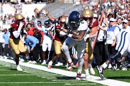 Oct 28, 2023; Chestnut Hill, Massachusetts, USA; Connecticut Huskies running back Camryn Edwards (0) rushes against the Boston College Eagles during the first half at Alumni Stadium. Mandatory Credit: Brian Fluharty-USA TODAY Sports