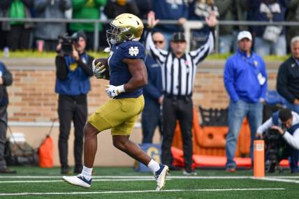Oct 28, 2023; South Bend, Indiana, USA; Notre Dame Fighting Irish running back Audric Estime (7) scores against the Pittsburgh Panthers in the second quarter at Notre Dame Stadium. Mandatory Credit: Matt Cashore-USA TODAY Sports