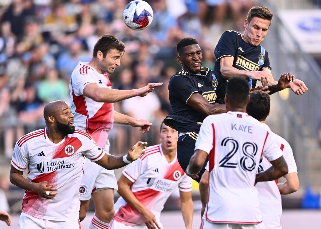 Oct 28, 2023; Philadelphia, PA, USA; New England Revolution defender Dave Romney (2) goes up for a header with Philadelphia Union defender Damion Lowe (17) and Philadelphia Union defender Jack Elliott (3) during the first half in game one in a round one match of the 2023 MLS Cup Playoffs at Subaru Park. Mandatory Credit: Kyle Ross-USA TODAY Sports