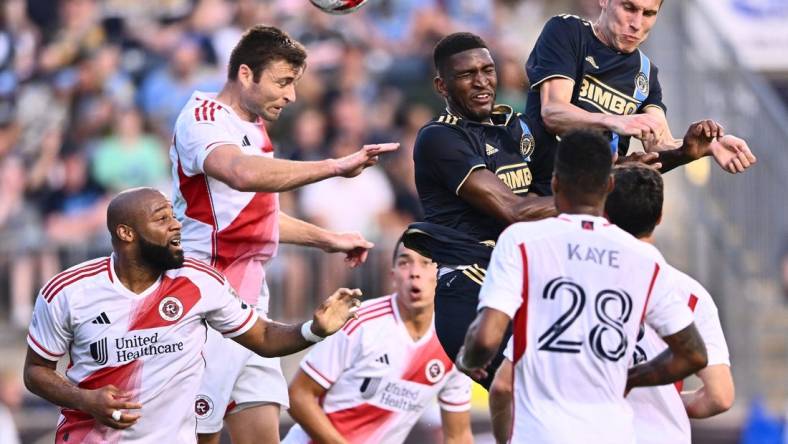 Oct 28, 2023; Philadelphia, PA, USA; New England Revolution defender Dave Romney (2) goes up for a header with Philadelphia Union defender Damion Lowe (17) and Philadelphia Union defender Jack Elliott (3) during the first half in game one in a round one match of the 2023 MLS Cup Playoffs at Subaru Park. Mandatory Credit: Kyle Ross-USA TODAY Sports