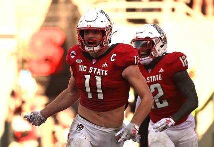 Oct 28, 2023; Raleigh, North Carolina, USA; North Carolina State Wolfpack linebacker Payton Wilson (11) celebrates after scoring a touchdown on an interception during the second half against the Clemson Tigers at Carter-Finley Stadium. Mandatory Credit: Rob Kinnan-USA TODAY Sports