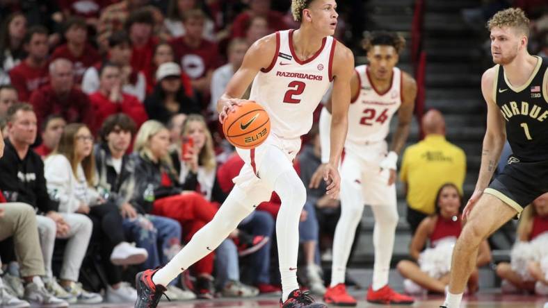 Arkansas Razorbacks forward Trevon Brazile (2) dribbles the ball against Purdue Boilermakers forward Caleb First (1) during the first half at Bud Walton Arena. Arkansas won 81-77. Mandatory Credit: Nelson Chenault-USA TODAY Sports