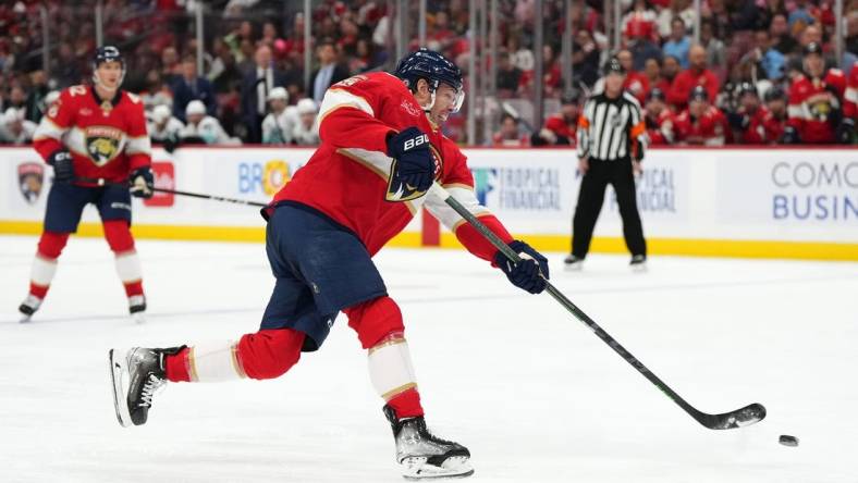 Oct 28, 2023; Sunrise, Florida, USA; Florida Panthers center Carter Verhaeghe (23) shoots the puck against the Seattle Kraken during the second period at Amerant Bank Arena. Mandatory Credit: Jasen Vinlove-USA TODAY Sports