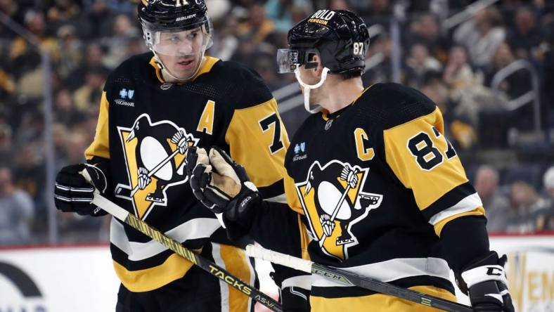 Oct 28, 2023; Pittsburgh, Pennsylvania, USA; Pittsburgh Penguins center Evgeni Malkin (71) listens to center Sidney Crosby (87) prior to a face-off against the Ottawa Senators during the first period at PPG Paints Arena. Mandatory Credit: Charles LeClaire-USA TODAY Sports