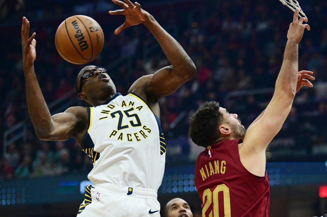 Oct 28, 2023; Cleveland, Ohio, USA; Indiana Pacers forward Jalen Smith (25) goes for a rebound against Cleveland Cavaliers forward Georges Niang (20) during the first half at Rocket Mortgage FieldHouse. Mandatory Credit: Ken Blaze-USA TODAY Sports