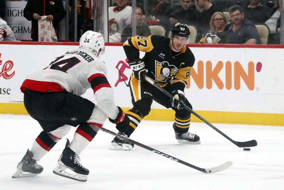 Oct 28, 2023; Pittsburgh, Pennsylvania, USA; Pittsburgh Penguins center Sidney Crosby (87) carries the puck as Ottawa Senators defenseman Jacob Bernard-Docker (24) defends during the first period at PPG Paints Arena. Mandatory Credit: Charles LeClaire-USA TODAY Sports