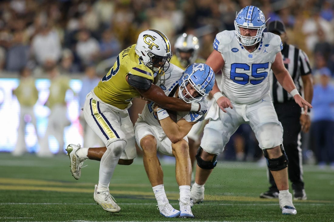 Oct 28, 2023; Atlanta, Georgia, USA; Georgia Tech Yellow Jackets linebacker Paul Moala (13) tackles North Carolina Tar Heels quarterback Drake Maye (10) in the second half at Bobby Dodd Stadium at Hyundai Field. Mandatory Credit: Brett Davis-USA TODAY Sports