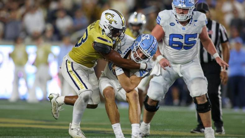 Oct 28, 2023; Atlanta, Georgia, USA; Georgia Tech Yellow Jackets linebacker Paul Moala (13) tackles North Carolina Tar Heels quarterback Drake Maye (10) in the second half at Bobby Dodd Stadium at Hyundai Field. Mandatory Credit: Brett Davis-USA TODAY Sports