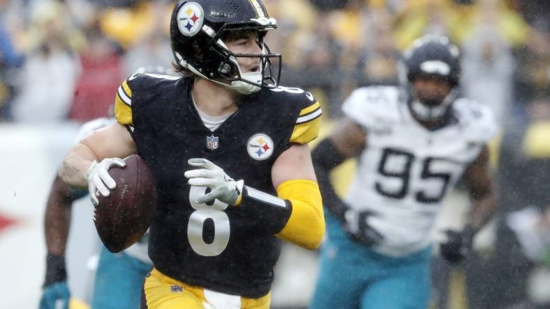 Oct 29, 2023; Pittsburgh, Pennsylvania, USA;  Pittsburgh Steelers quarterback Kenny Pickett (8) scrambles with the ball against the Jacksonville Jaguars during the first quarter at Acrisure Stadium. Mandatory Credit: Charles LeClaire-USA TODAY Sports