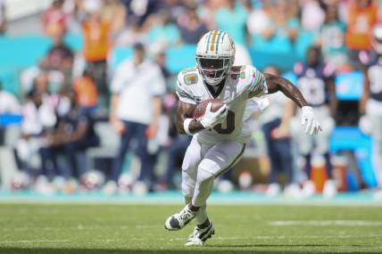 Oct 29, 2023; Miami Gardens, Florida, USA; Miami Dolphins wide receiver Tyreek Hill (10) runs with the football against the New England Patriots during the second quarter at Hard Rock Stadium. Mandatory Credit: Sam Navarro-USA TODAY Sports