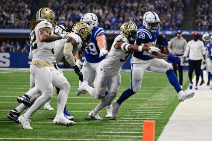 Oct 29, 2023; Indianapolis, Indiana, USA; Indianapolis Colts running back Jonathan Taylor (28) is pushed out of bounds by New Orleans Saints safety Jordan Howden (31) during the first quarter at Lucas Oil Stadium. Mandatory Credit: Marc Lebryk-USA TODAY Sports