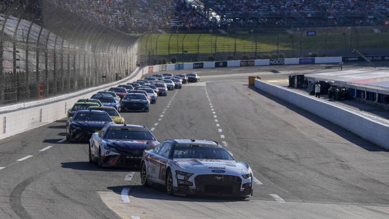 Oct 29, 2023; Martinsville, Virginia, USA; NASCAR Cup Series driver Ryan Blaney (12) leads the pack during the NASCAR Xfinity 500 at Martinsville Speedway. Mandatory Credit: David Yeazell-USA TODAY Sports