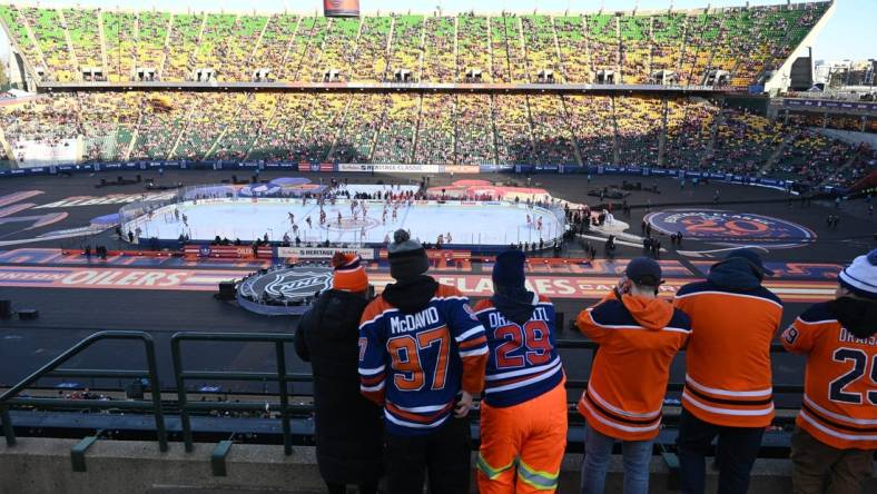 Oct 29, 2023; Edmonton, Alberta, CAN; Fans watch the pre game skate before game action of the Edmonton Oilers as they take on the Calgary Flames in the 2023 Heritage Classic ice hockey game at Commonwealth Stadium. Mandatory Credit: Walter Tychnowicz-USA TODAY Sports