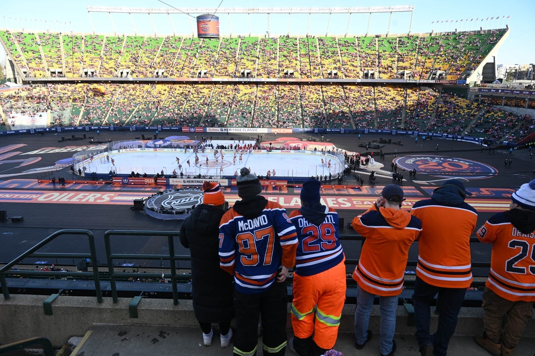 Oct 29, 2023; Edmonton, Alberta, CAN; Fans watch the pre game skate before game action of the Edmonton Oilers as they take on the Calgary Flames in the 2023 Heritage Classic ice hockey game at Commonwealth Stadium. Mandatory Credit: Walter Tychnowicz-USA TODAY Sports