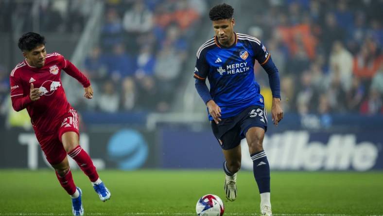 Oct 29, 2023; Cincinnati, OH, USA; FC Cincinnati defender Ian Murphy (32) dribbles the ball against the New York Red Bulls during the first half of game one in a round one match of the 2023 MLS Cup Playoffs at TQL Stadium. Mandatory Credit: Aaron Doster-USA TODAY Sports