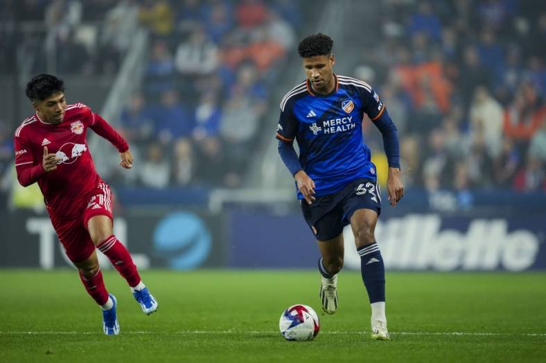 Oct 29, 2023; Cincinnati, OH, USA; FC Cincinnati defender Ian Murphy (32) dribbles the ball against the New York Red Bulls during the first half of game one in a round one match of the 2023 MLS Cup Playoffs at TQL Stadium. Mandatory Credit: Aaron Doster-USA TODAY Sports