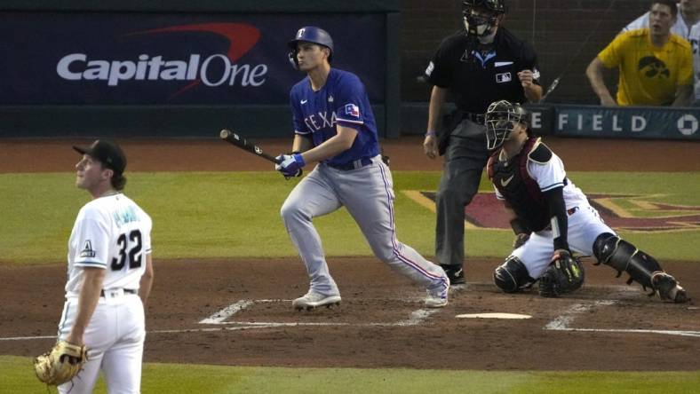 Oct 30, 2023; Phoenix, AZ, USA; Texas Rangers shortstop Corey Seager (5) hits a two-run home off Arizona Diamondbacks pitcher Brandon Pfaadt (32) during the third inning in game three of the 2023 World Series at Chase Field. Mandatory Credit: Rick Scuteri-USA TODAY Sports