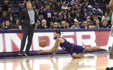 Mar 7, 2020; Evanston, Illinois, USA; Northwestern Wildcats guard Boo Buie (0) dives for the ball as Northwestern Wildcats head coach Chris Collins stands nearby during the second half at Welsh-Ryan Arena. Mandatory Credit: David Banks-USA TODAY Sports