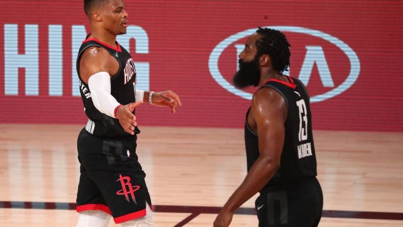 Sep 8, 2020; Lake Buena Vista, Florida, USA; Houston Rockets guard Russell Westbrook (left) celebrates with guard James Harden (13) after dunking against the Los Angeles Lakers during the first half of game three in the second round of the 2020 NBA Playoffs at AdventHealth Arena. Mandatory Credit: Kim Klement-USA TODAY Sports