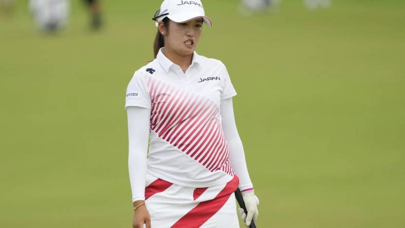 Aug 7, 2021; Tokyo, Japan; Mone Inami (JPN) reacts after her putt on the 18th hole during the final round of the women's individual stroke play of the Tokyo 2020 Olympic Summer Games at Kasumigaseki Country Club. Mandatory Credit: Michael Madrid-USA TODAY Sports