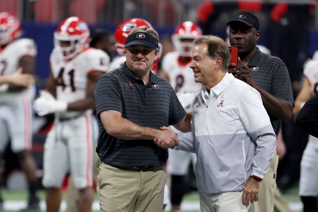 Dec 4, 2021; Atlanta, GA, USA; Georgia Bulldogs head coach Kirby Smart greets Alabama Crimson Tide head coach Nick Saban before the SEC championship game at Mercedes-Benz Stadium. Mandatory Credit: Jason Getz-USA TODAY Sports