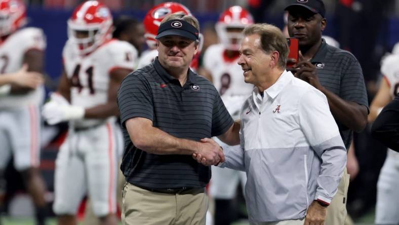 Dec 4, 2021; Atlanta, GA, USA; Georgia Bulldogs head coach Kirby Smart greets Alabama Crimson Tide head coach Nick Saban before the SEC championship game at Mercedes-Benz Stadium. Mandatory Credit: Jason Getz-USA TODAY Sports