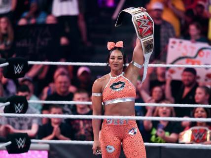 This year's Big 12 conference championship Most Outstanding Player receives a custom-made belt, such as the version WWE women's champion Bianca Belair raises in the file photo from an event in Knoxville, Tenn., in 2022. 

Kns Biancahomecoming 0427