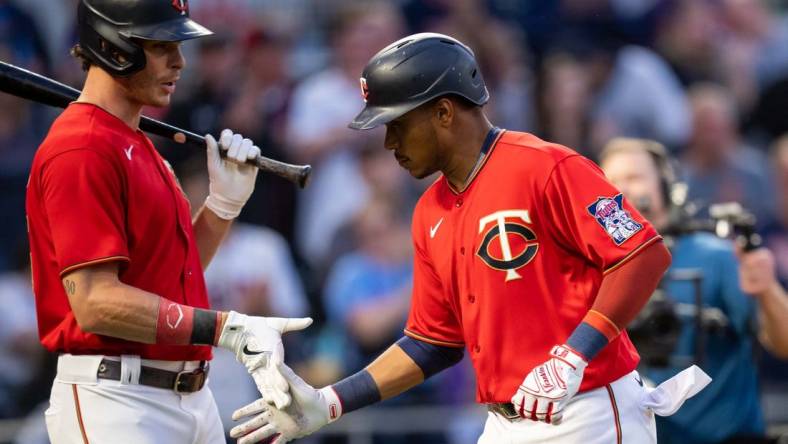 Jun 7, 2022; Minneapolis, Minnesota, USA;  Minnesota Twins right fielder Max Kepler (26) congratulates shortstop Jorge Polanco (11) after scoring against the New York Yankees in the fifth inning at Target Field. Mandatory Credit: Brad Rempel-USA TODAY Sports