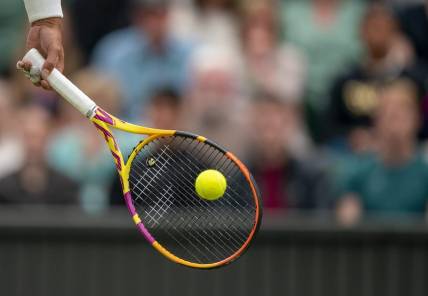 Jun 30, 2022; London, United Kingdom; A detail view of a ball on the racket of Rafael Nadal (ESP) during his match against Ricardas Berankis (LTU) on day four at All England Lawn Tennis and Croquet Club. Mandatory Credit: Susan Mullane-USA TODAY Sports