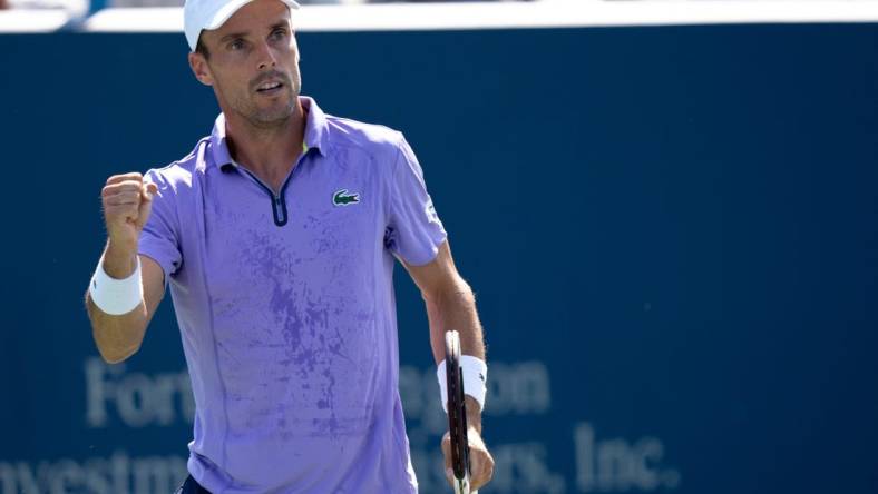 Roberto Bautista Agut reacts to winning a point against Borna Coric during the second set of their match in the Western & Southern Open at the Lindner Family Tennis Center in Mason, Ohio, on Thursday, Aug. 18, 2022.

Western Southern Open Day Four Night 828