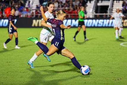 Sep 24, 2022; Cary, North Carolina, USA; North Carolina Courage defender Merritt Mathias (11) controls the ball as New Jersey/New York Gotham FC forward Paige Monaghan (4) defends during the second half at WakeMed Soccer Park. Mandatory Credit: Jaylynn Nash-USA TODAY Sports