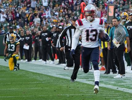 New England Patriots defensive back Jack Jones returns an interception thrown by Green Bay Packers quarterback Aaron Rodgers for a touchdown during the second quarter of their game Sunday, October 2, 2022 at Lambeau Field in Green Bay, Wis.

Packers02 5