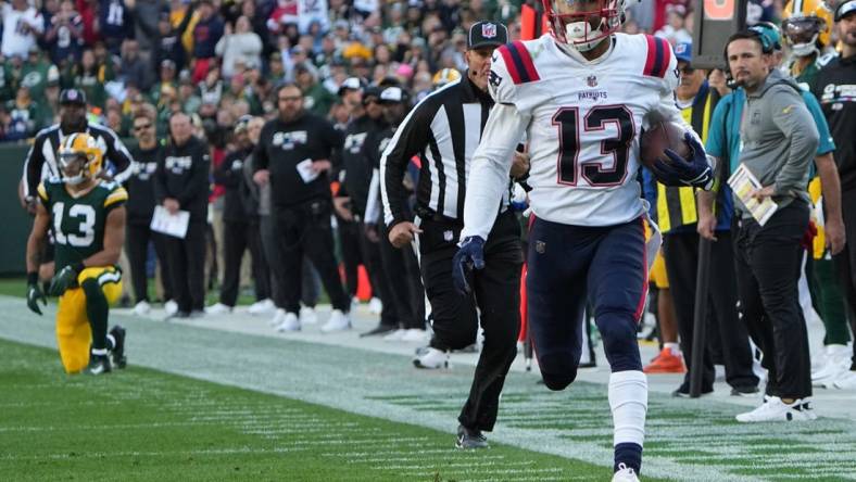 New England Patriots defensive back Jack Jones returns an interception thrown by Green Bay Packers quarterback Aaron Rodgers for a touchdown during the second quarter of their game Sunday, October 2, 2022 at Lambeau Field in Green Bay, Wis.

Packers02 5