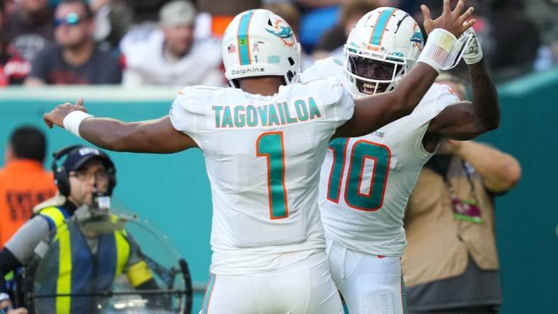 Nov 13, 2022; Miami Gardens, Florida, USA; Miami Dolphins wide receiver Tyreek Hill (10) celebrates the touchdown of running back quarterback Tua Tagovailoa (1)  during the second half at Hard Rock Stadium. Mandatory Credit: Jasen Vinlove-USA TODAY Sports