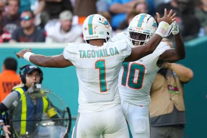 Nov 13, 2022; Miami Gardens, Florida, USA; Miami Dolphins wide receiver Tyreek Hill (10) celebrates the touchdown of running back quarterback Tua Tagovailoa (1)  during the second half at Hard Rock Stadium. Mandatory Credit: Jasen Vinlove-USA TODAY Sports