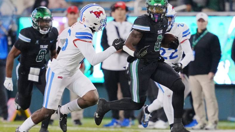 Nov 17, 2022; New Orleans, Louisiana, USA; Tulane Green Wave running back Shaadie Clayton-Johnson (0) runs the ball against the Southern Methodist Mustangs during the second half at Yulman Stadium. Mandatory Credit: Andrew Wevers-USA TODAY Sports