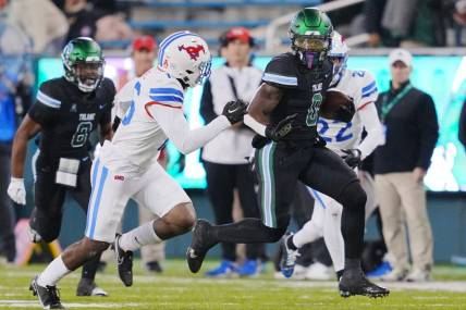 Nov 17, 2022; New Orleans, Louisiana, USA; Tulane Green Wave running back Shaadie Clayton-Johnson (0) runs the ball against the Southern Methodist Mustangs during the second half at Yulman Stadium. Mandatory Credit: Andrew Wevers-USA TODAY Sports