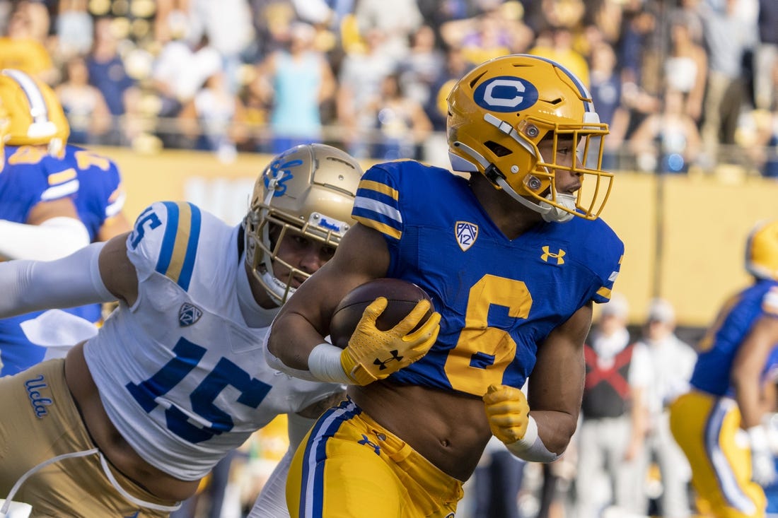 November 25, 2022; Berkeley, California, USA; California Golden Bears running back Jaydn Ott (6) runs the football against UCLA Bruins linebacker Laiatu Latu (15) during the first quarter at California Memorial Stadium. Mandatory Credit: Kyle Terada-USA TODAY Sports