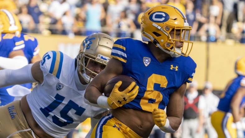 November 25, 2022; Berkeley, California, USA; California Golden Bears running back Jaydn Ott (6) runs the football against UCLA Bruins linebacker Laiatu Latu (15) during the first quarter at California Memorial Stadium. Mandatory Credit: Kyle Terada-USA TODAY Sports