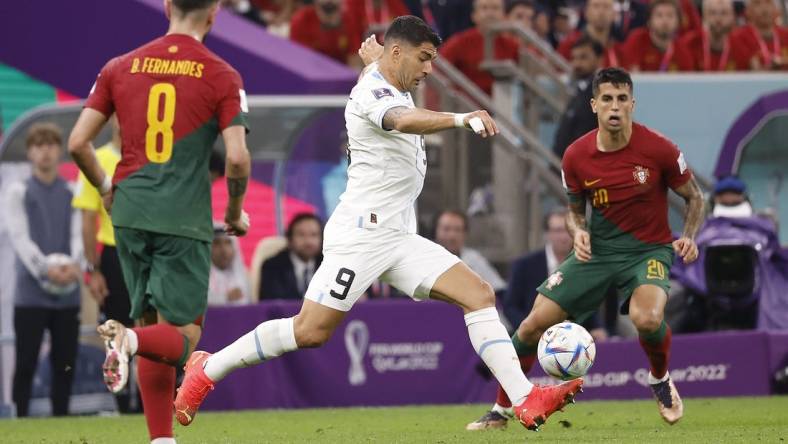 Nov 28, 2022; Lusail, Qatar; Uruguay forward Luis Suarez (9) shoots on goal against Portugal during the second half of the group stage match in the 2022 World Cup at Lusail Stadium. Mandatory Credit: Yukihito Taguchi-USA TODAY Sports