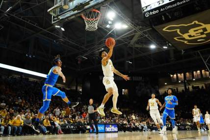 Feb 26, 2023; Boulder, Colorado, USA; Colorado Buffaloes guard KJ Simpson (2) shoots the ball past UCLA Bruins guard Jaime Jaquez Jr. (24) in the first half at the CU Events Center. Mandatory Credit: Ron Chenoy-USA TODAY Sports