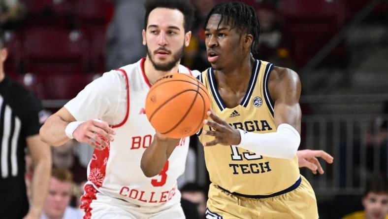 Mar 4, 2023; Chestnut Hill, Massachusetts, USA; Georgia Tech Yellow Jackets guard Miles Kelly (13) passes the ball past Boston College Eagles guard Jaeden Zackery (3) during the second half at the Conte Forum. Mandatory Credit: Brian Fluharty-USA TODAY Sports