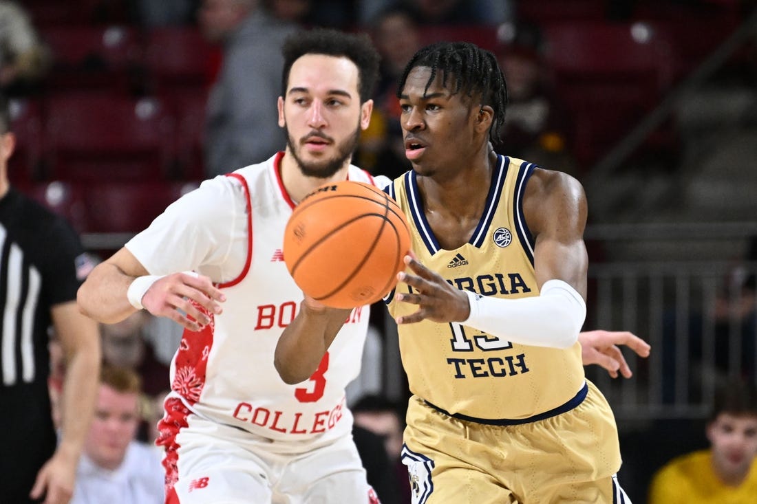 Mar 4, 2023; Chestnut Hill, Massachusetts, USA; Georgia Tech Yellow Jackets guard Miles Kelly (13) passes the ball past Boston College Eagles guard Jaeden Zackery (3) during the second half at the Conte Forum. Mandatory Credit: Brian Fluharty-USA TODAY Sports
