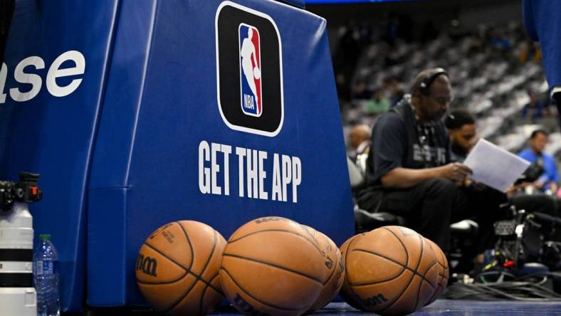 Mar 5, 2023; Dallas, Texas, USA; A view of the NBA logo and NBA app logo and basketballs in front of the base during warms up before the game between the Dallas Mavericks and the Suns at the American Airlines Center. Mandatory Credit: Jerome Miron-USA TODAY Sports